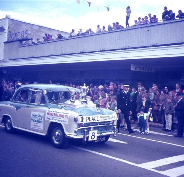 1969 Blossom Festival parade — First Place car rally — Roach's department store — crowd on verandah roof