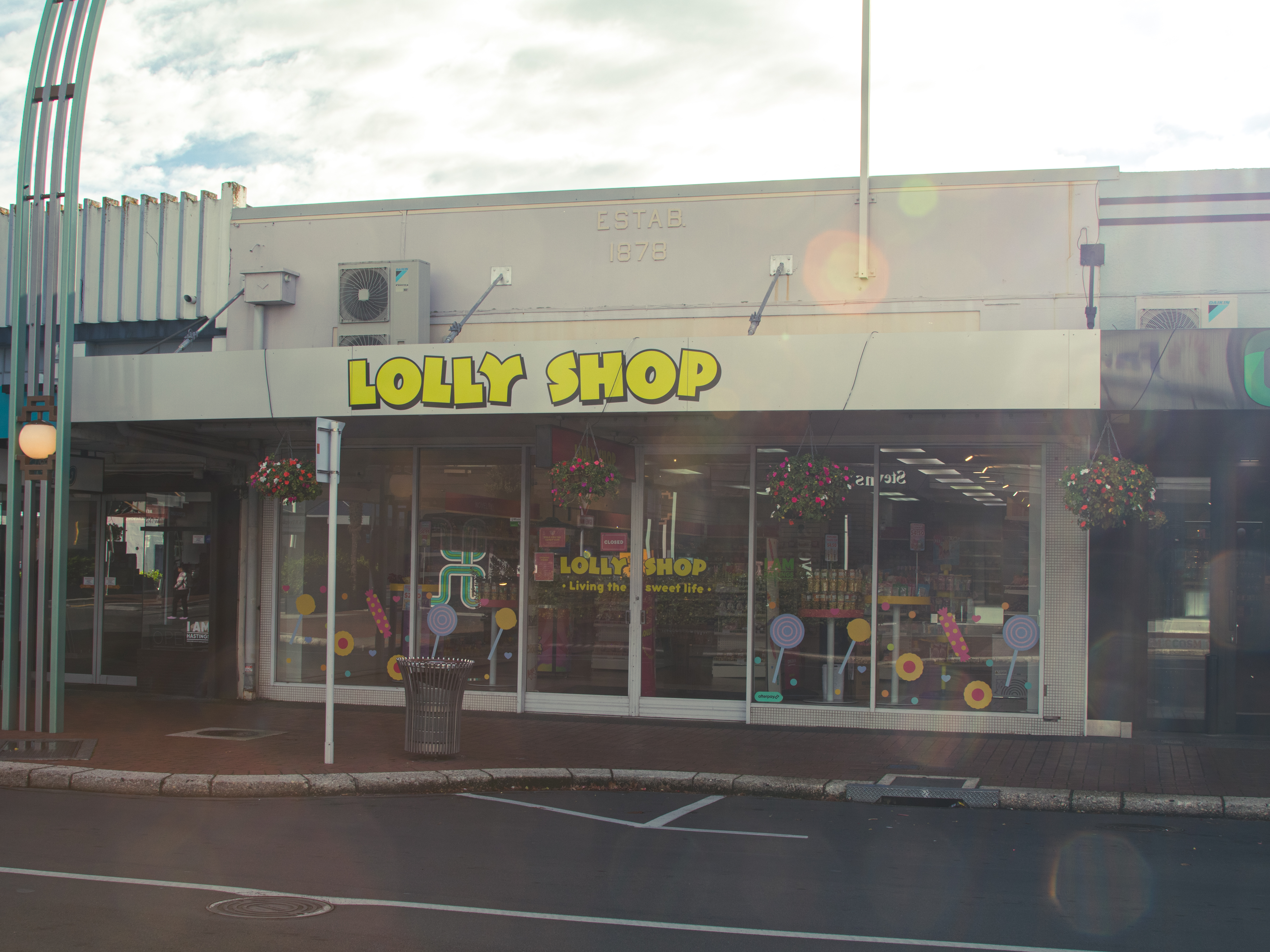 ESTAB. 1878 · above the Lolly Shop · 200 block HSW